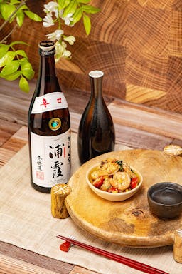 Urakasumi “Karakuchi” Honjozo, with a tokkuri and ochoko, served with a grilled shrimp and petite tomato