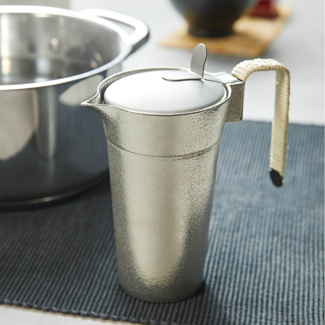 “Nousaku” Tin Chirori Sake Warmer With Lid, on a table