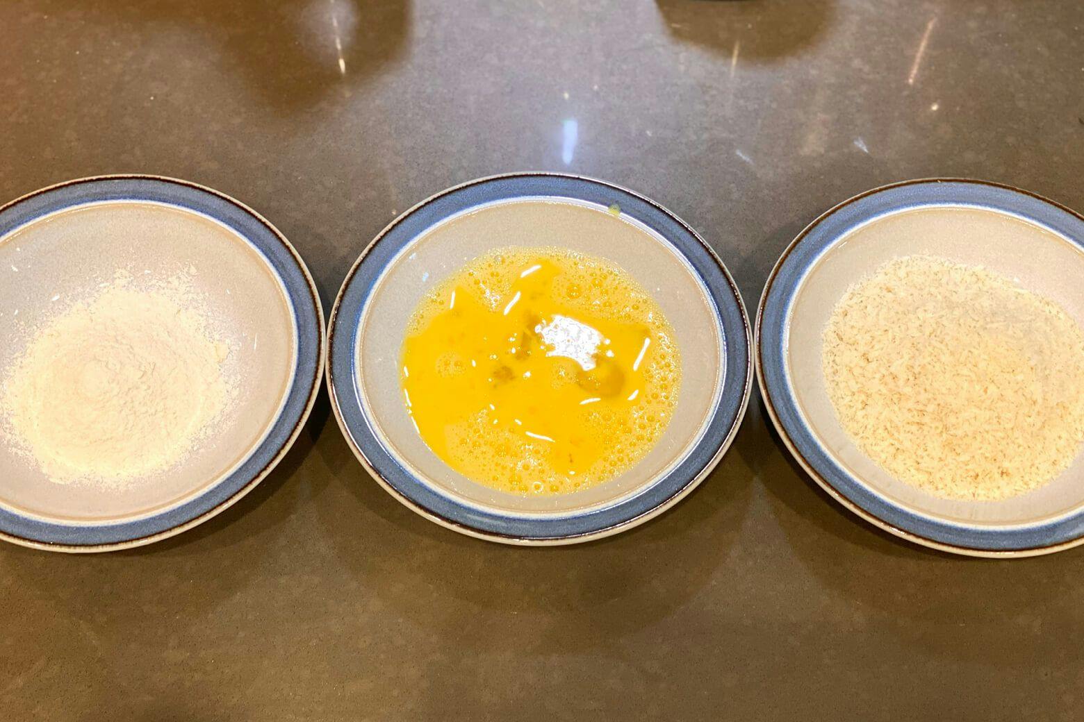 Preparing flour, beaten eggs, and panko in separate bowls