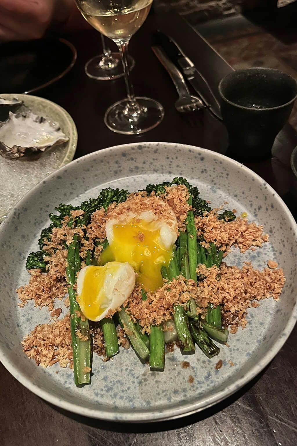 Grilled broccolini with charred soy sauce, poached egg, panko and tarragon. | Photo by Taylor Markarian.