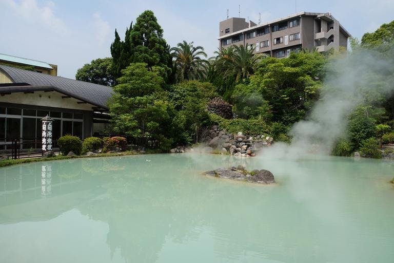 Shiraike Jigoku, or White Pond Hell, is a milky, blue-green hot spring surrounded by gardens.