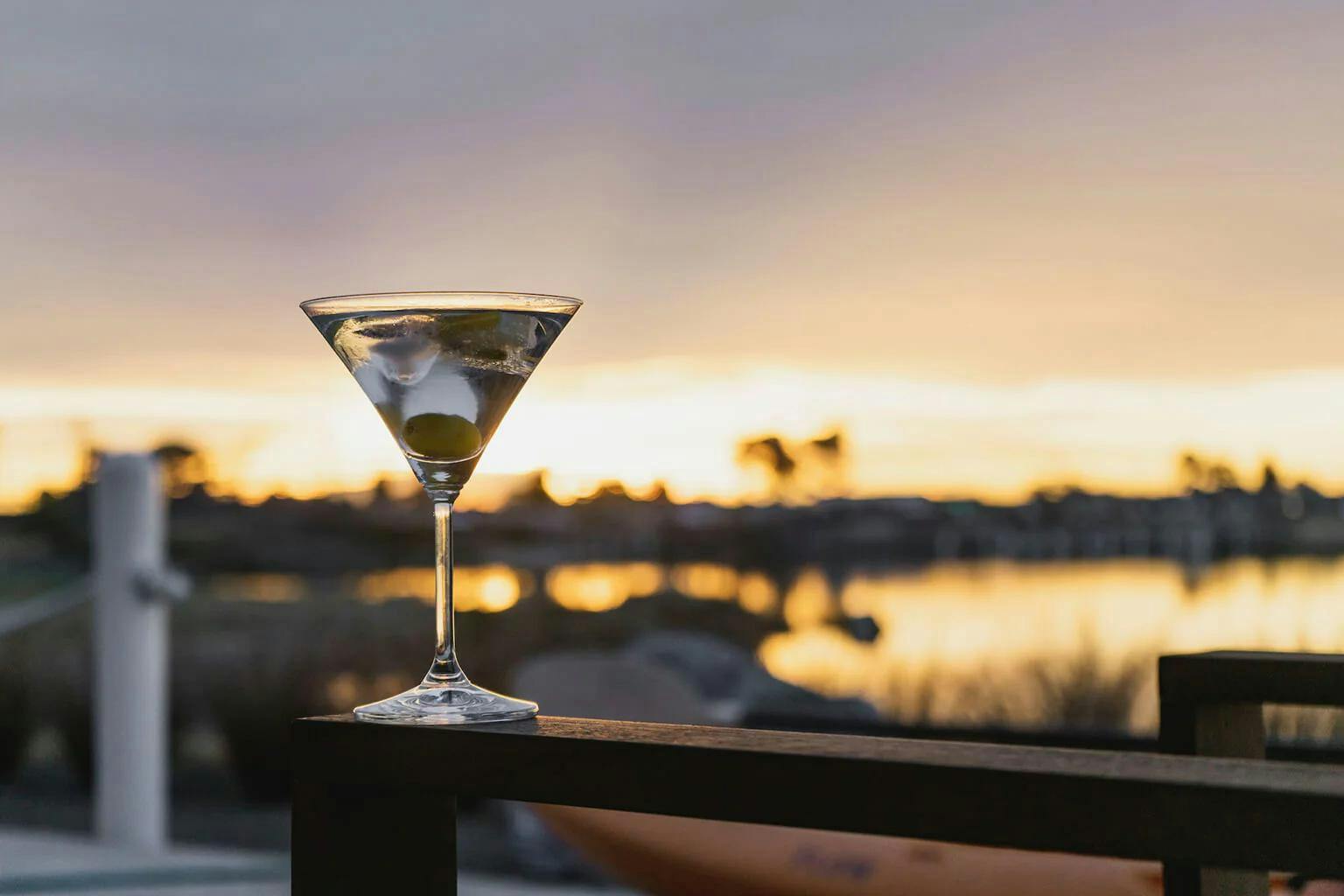 A classic martini with green cocktail olives.
