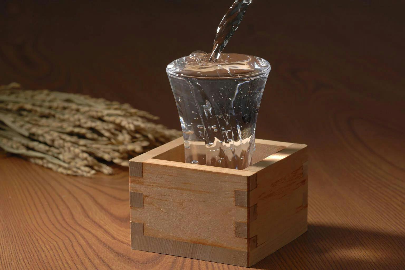 Sake is poured “mokkiri” style, overflowing into the wooden “masu” as a demonstration of generosity and hospitality.