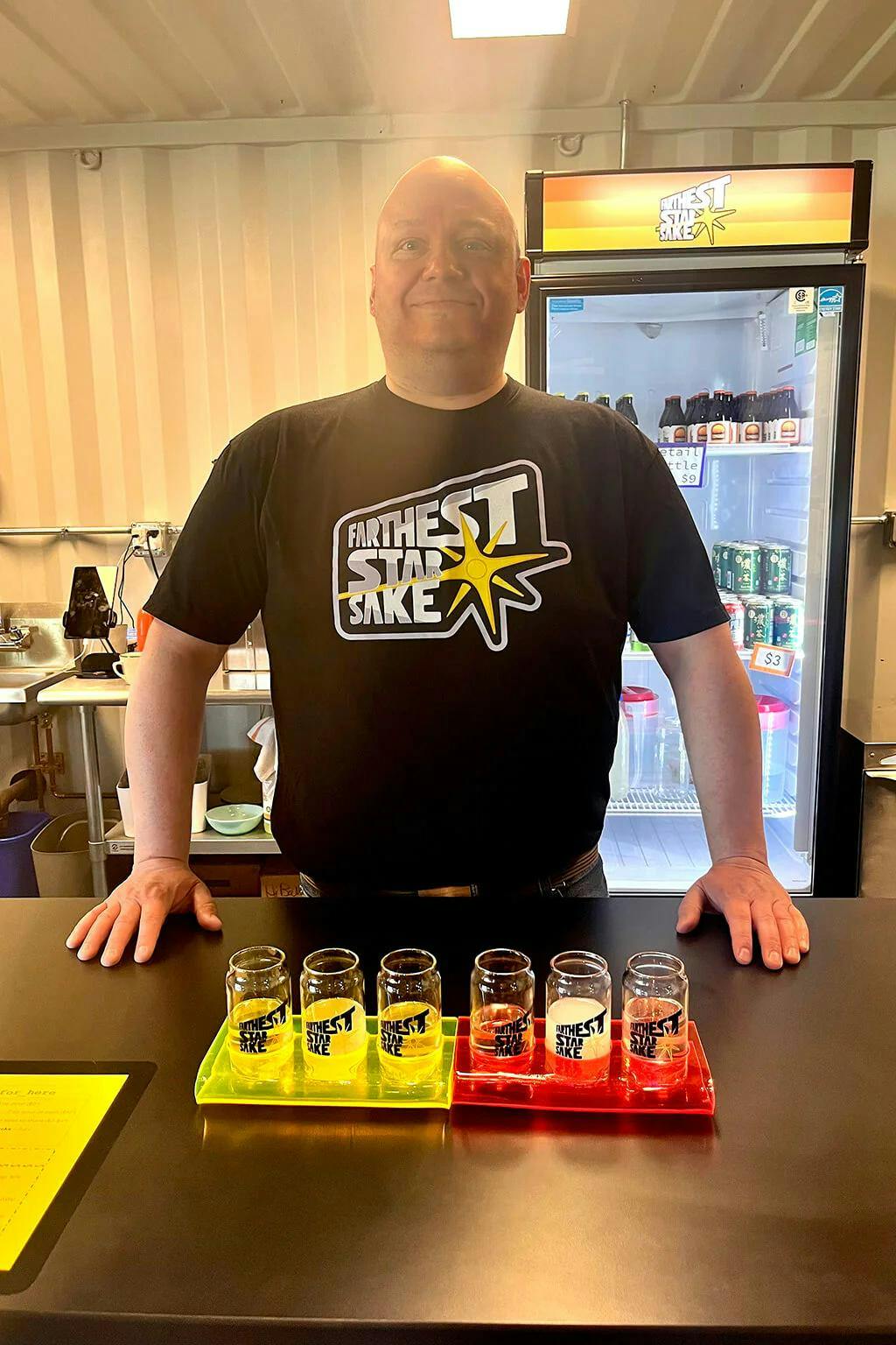 Farthest Star Sake owner and brewer Todd Bellomy offers sake flights in his Medfield, Massachusetts taproom. Left to right: “In A Strange Land,” “Mountains on the Moon,” “Needs of the Many,” “Coconut Business,” “Spruce Dern Returns.” Flavored sake offerings often rotate
