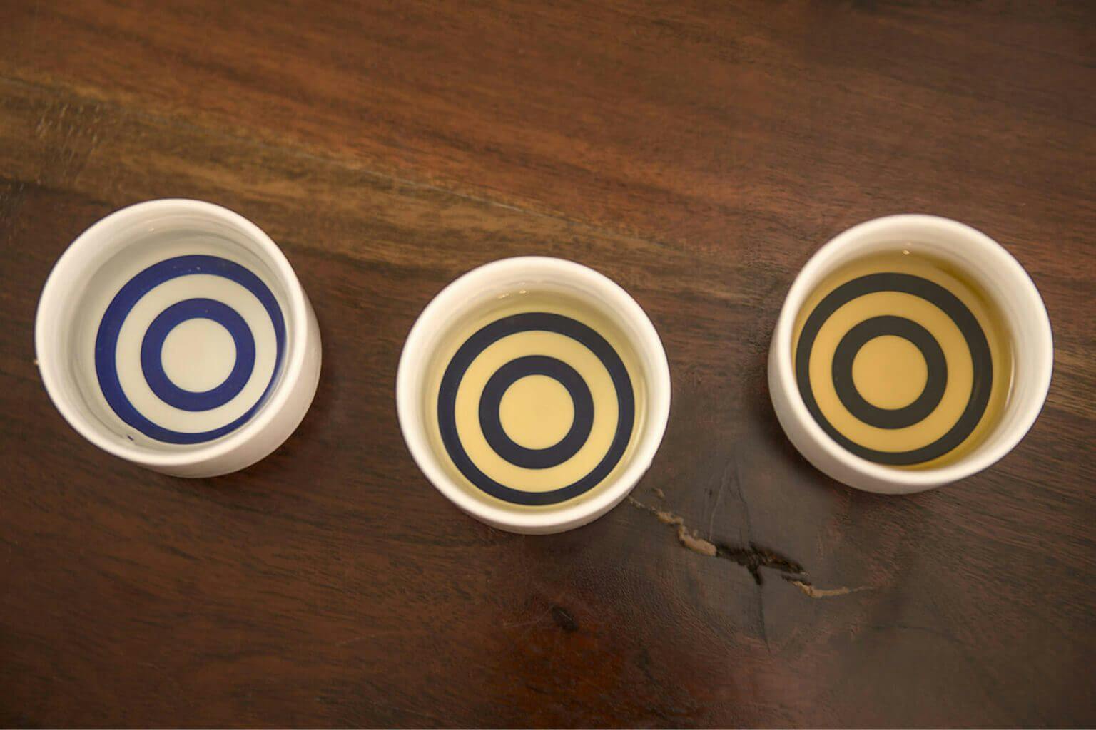 The contrast provided by the blue rings of the white janome cup make it easier to analyze sake color.
