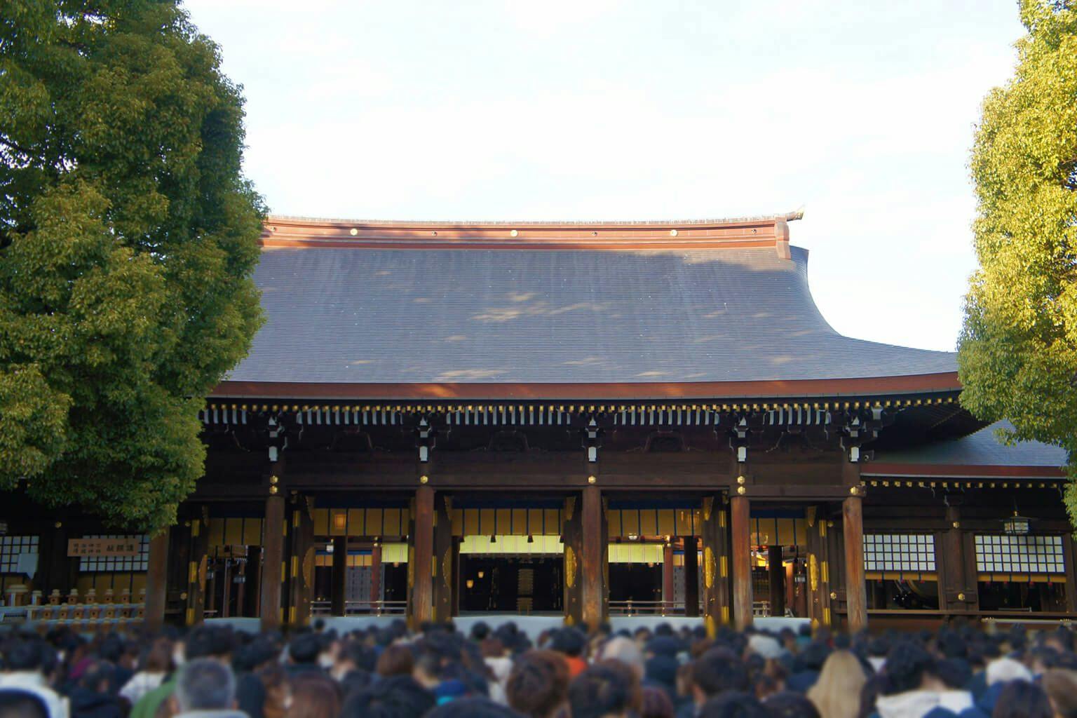 A large crowd of people gathers for hatsumode at Meiji Shrine in Tokyo