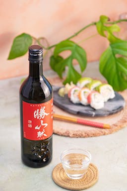 Katsuyama “Ken” Junmai Ginjo, with a clear glass, served with california rolls