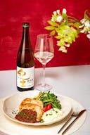Heiwa “KID” Junmai, with a wine glass, served with a ginger pork with egg tartar sauce