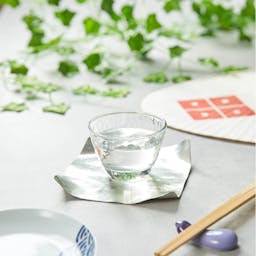 “Aderia” Ginjo Guinomi Glass, on a table