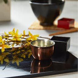 “Hana” Tin Guinomi Cup (With Copper Mirror Finish), on a table