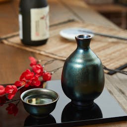 “Mino no Takumi” Black With Luster Glaze Sake Set, on a table