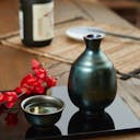 “Mino no Takumi” Black Tokkuri With Luster Glaze, on a table