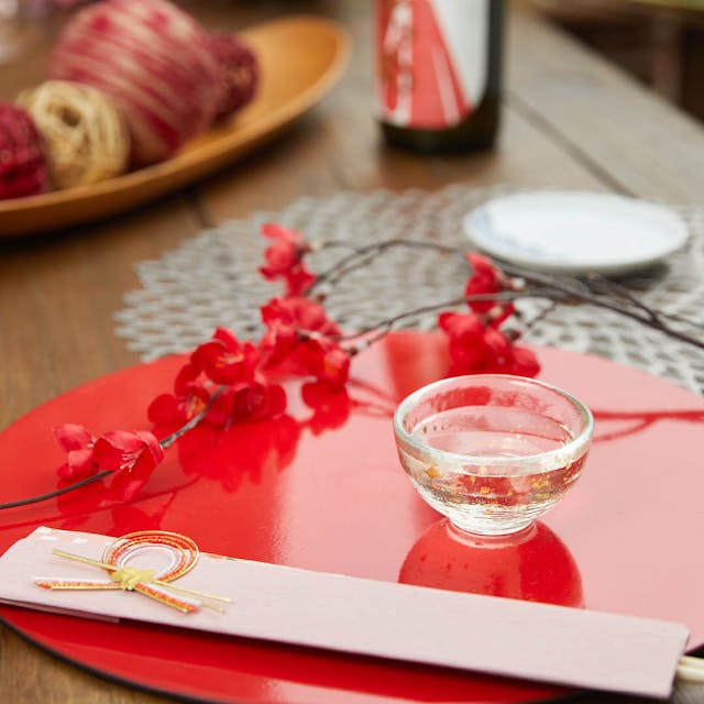 “Nishiki” Gold Flake Guinomi Glass (Clear), on a table