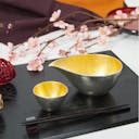 “Nousaku” Tin Gold Sake Set, on a table