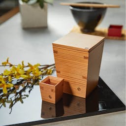 “Omoeraku” Nikko Cedar Sake Set With Sakazuki, on a table