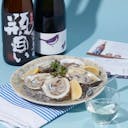 Dewanoyuki “Bingakoi” Junmai Daiginjo and Niwa no Uguisu “50” Junmai Daiginjo with a clear glass, served with oyster