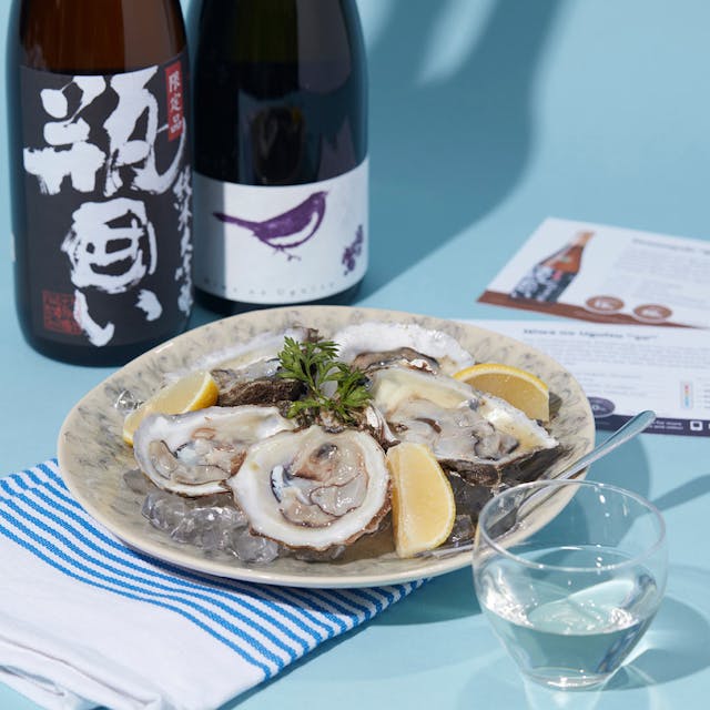 Dewanoyuki “Bingakoi” Junmai Daiginjo and Niwa no Uguisu “50” Junmai Daiginjo with a clear glass, served with oyster