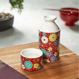 “Seikou” Sakazutsu Sake Set (Umekiku red), on a table