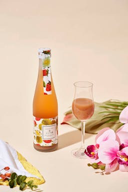 Homare “Strawberry” Nigori flavored nigori with a champagne flute