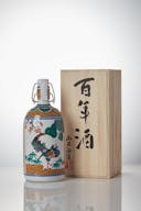 Nishide “100 Year” Junmai Daiginjo, standing in front of a product box